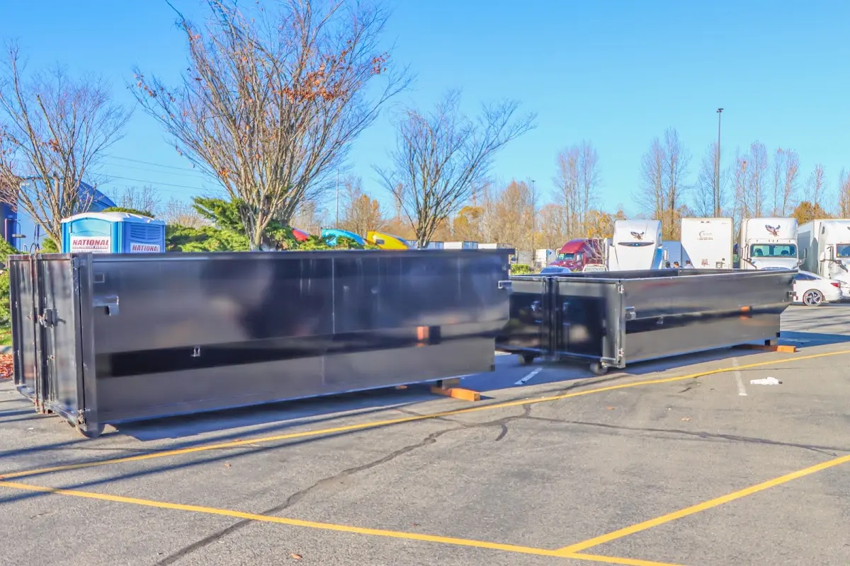 Professional dumpster rental service with roll-off container on residential driveway in Loudon